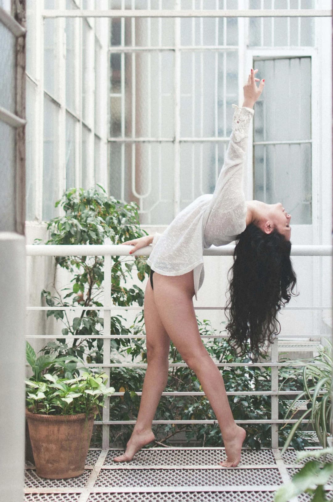 Woman Dancing on Balcony